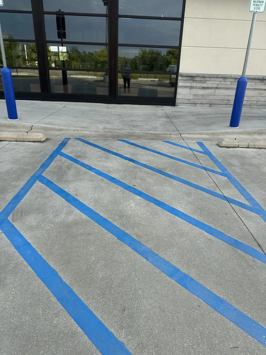 After: ADA access aisle concrete cleaned and tire marks removed by Fresh Start Surface Solutions, Jacksonville, NC