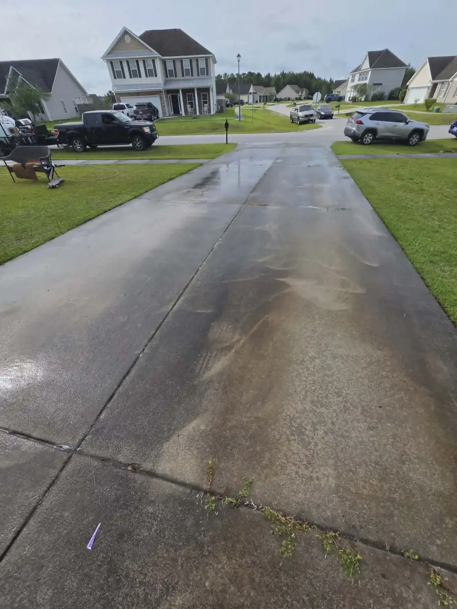 Before: concrete driveway with staining, oil spots, and biological growth in Onslow County, NC