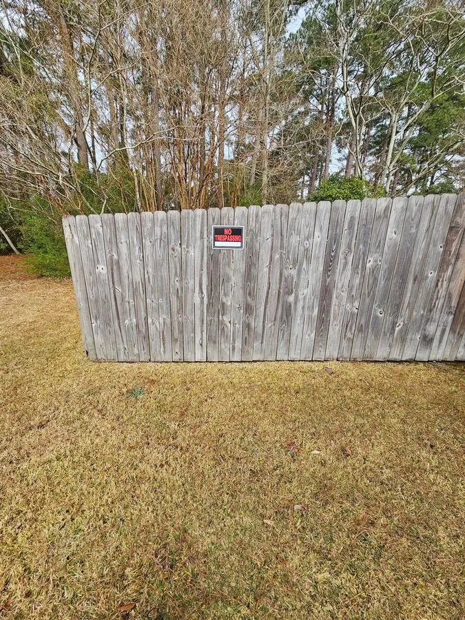 Before: wood privacy fence weathered grey with mold and mildew