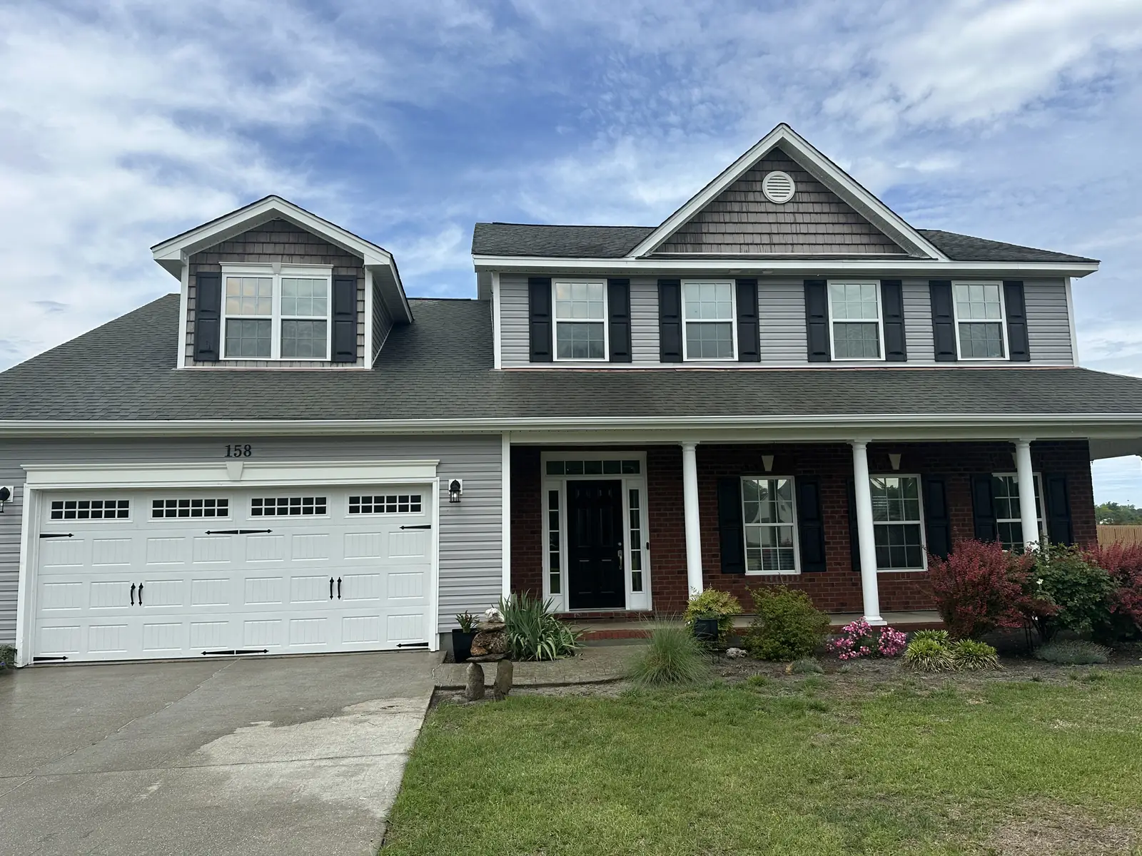 After: two-story gray vinyl house fully cleaned with soft wash treatment in Jacksonville NC