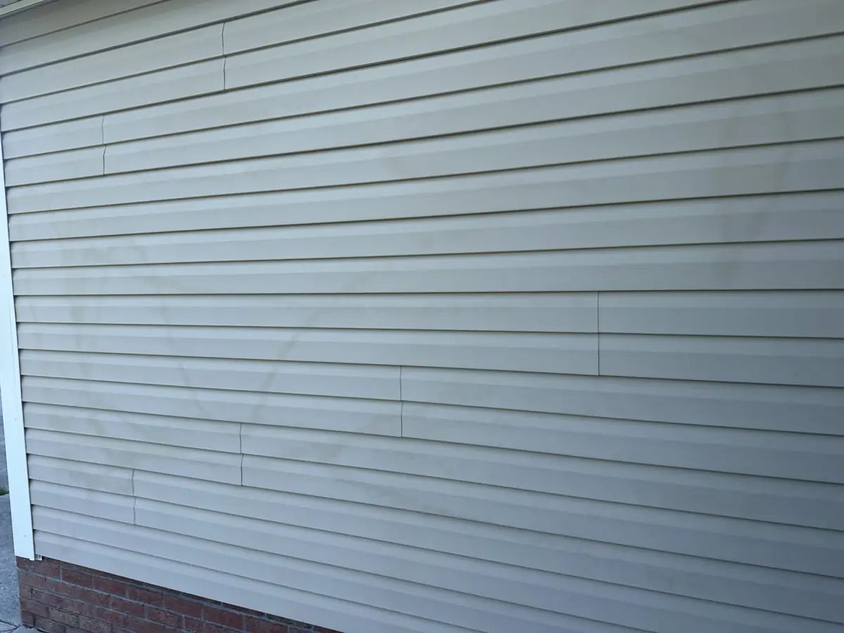 Before: chalky, oxidized white vinyl siding with a dull, faded film on a Jacksonville, NC home