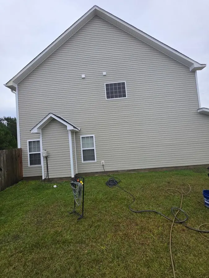 After: house corner and gutters cleaned, stains fully removed