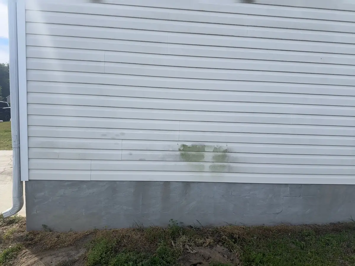Before: white colonial home side with algae and weathering before Fresh Start soft wash