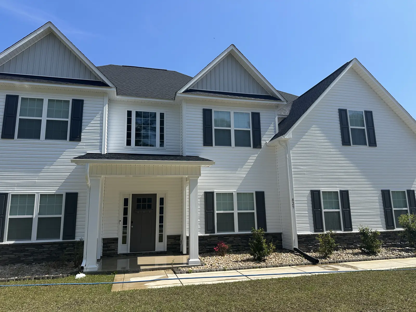 After: white colonial house fully restored with soft wash treatment — Jacksonville, NC