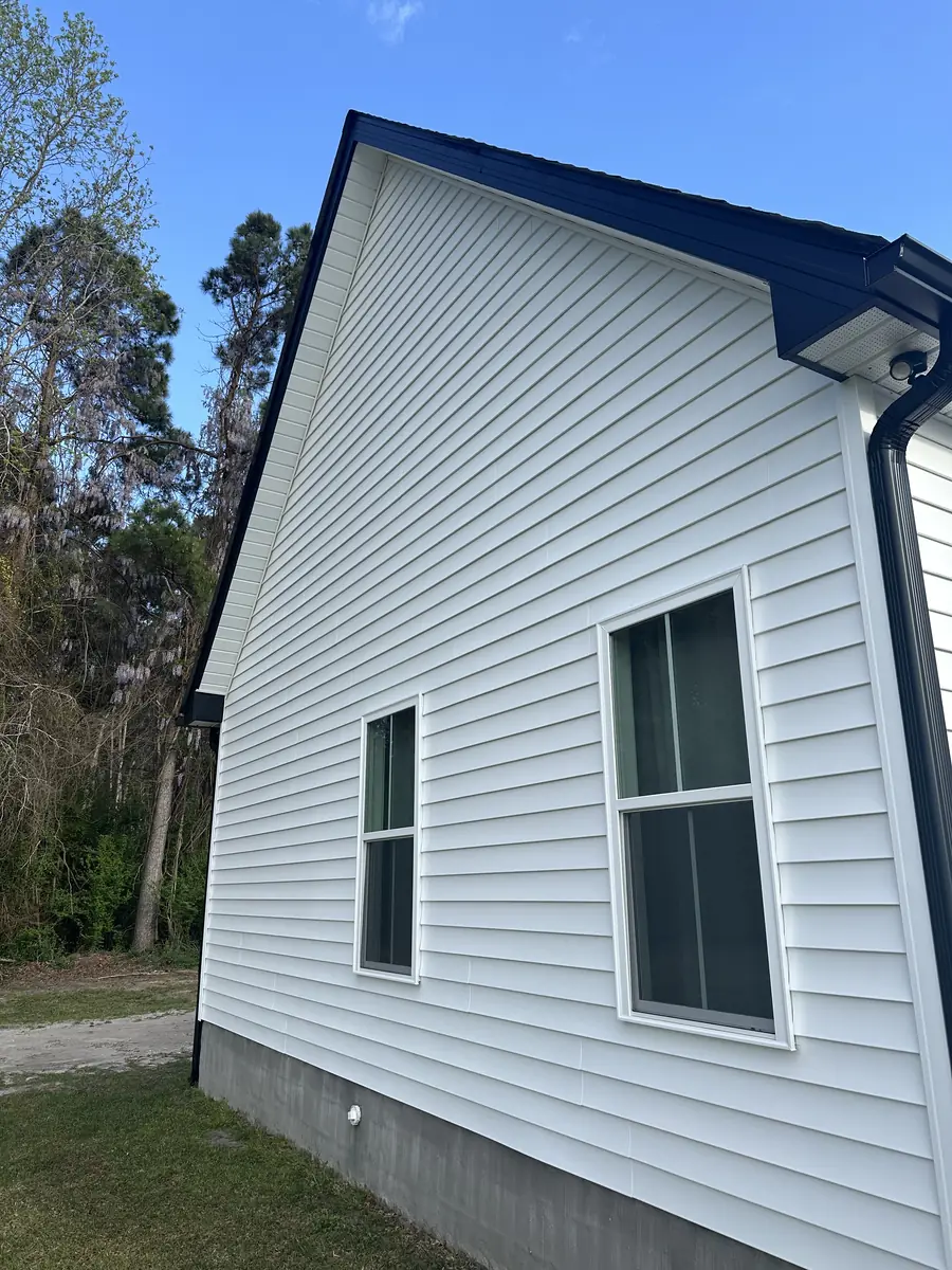 White farmhouse after a full exterior soft wash in the Camp Lejeune service area
