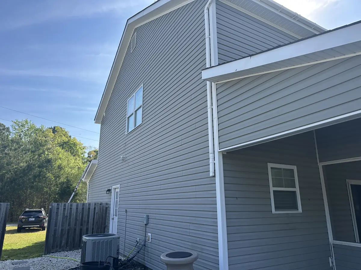 Fresh Start Surface Solutions soft-washing a North Topsail Beach home, action shot