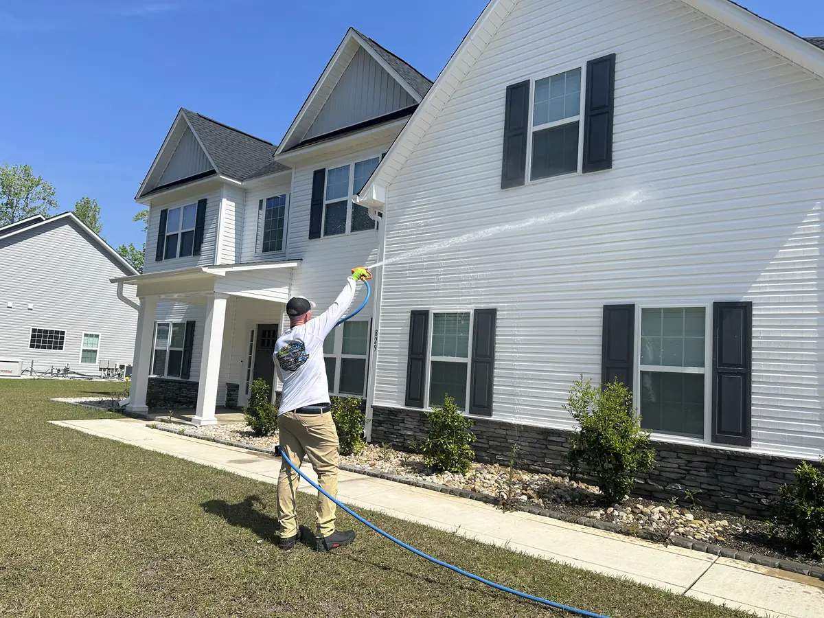 Soft wash in progress on a white colonial home in Sneads Ferry, NC